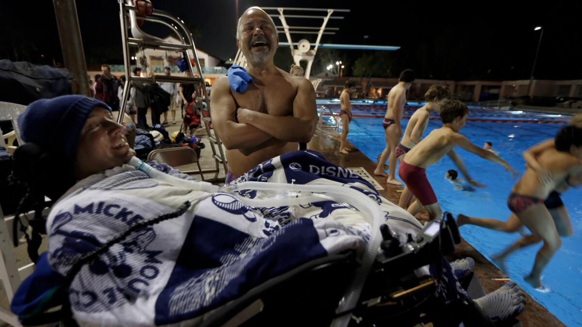 Diving coach Lenny Larsen talks with his diver Luis Bahamon at the the Rose Bowl Aquatics Center in Pasadena.