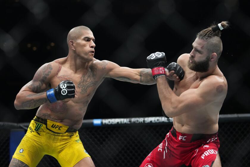 FILE - Brazil's Alex Pereira, left, punches Czech Republic's Jiri Prochazka during the second round of a light heavyweight title bout at the UFC 295 mixed martial arts event, early Nov. 12, 2023, in New York. Pereira and Jamahal Hill meet for the light heavyweight championship in UFC 300 on Saturday night, April 13, in Las Vegas. They headline a card that includes 10 other current or former champions. (AP Photo/Frank Franklin II)