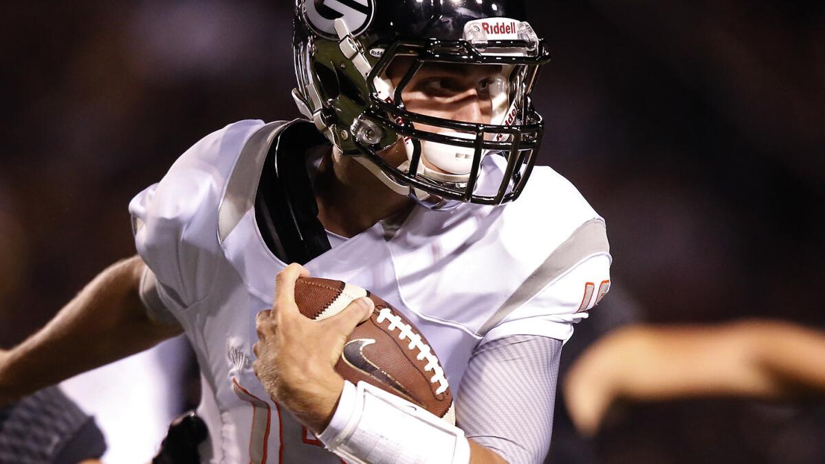 Las Vegas Bishop Gorman quarterback Tate Martell breaks away from an Anaheim Servite defender during a game at Cerritos College on Aug. 29, 2014.
