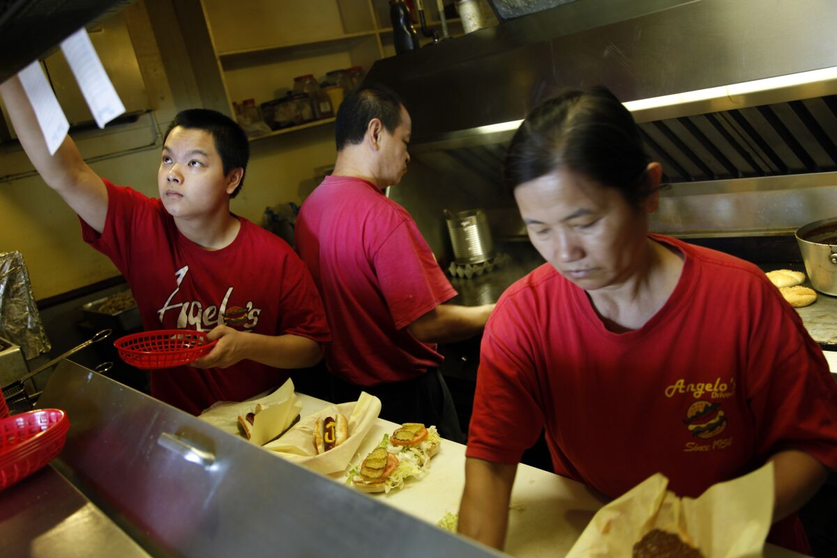 Aug. 2013 photo of Ken Chea, Kay Lim, working with their son, Tim, left, working at Angelo's.