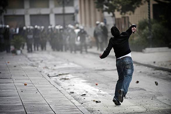 Rioting in Greece - throwing rocks on riot police