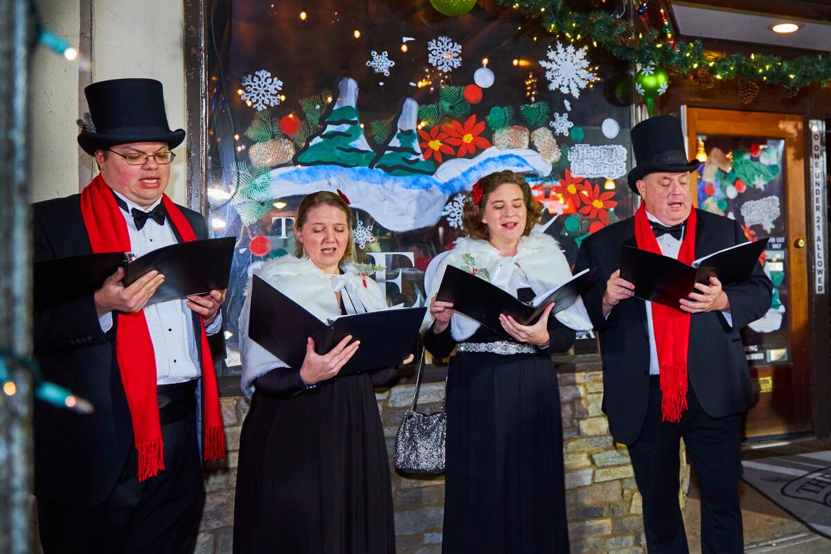 Carolers are part of the fun at Holiday in the Village in La Mesa.