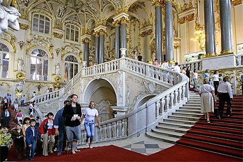 Opulence abounds as visitors climb the main staircase of the Winter Palace, once the home of Russian Czars.