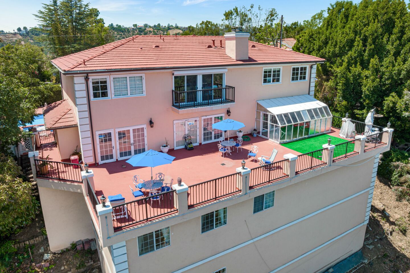The four-story home has a deck in the back on an upper floor that is furnished.