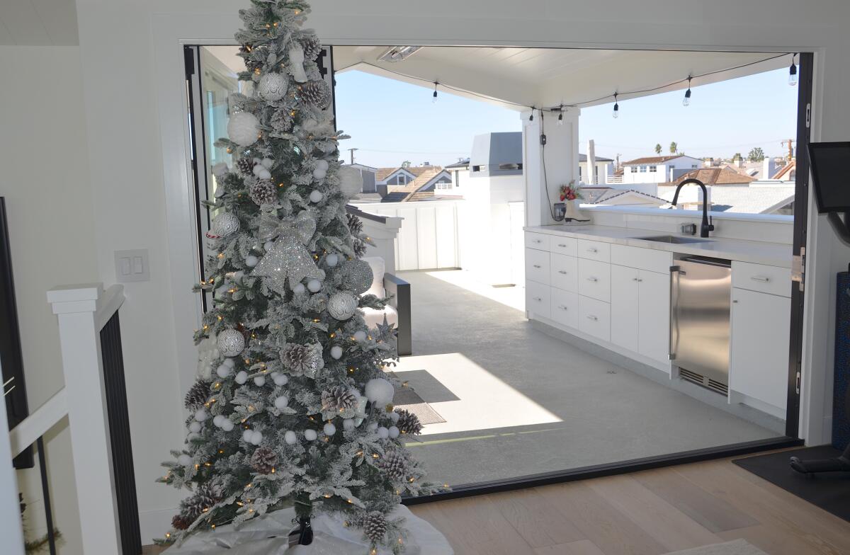 The Perrys' Sapphire Avenue home has a second Christmas tree on the third-floor entry.