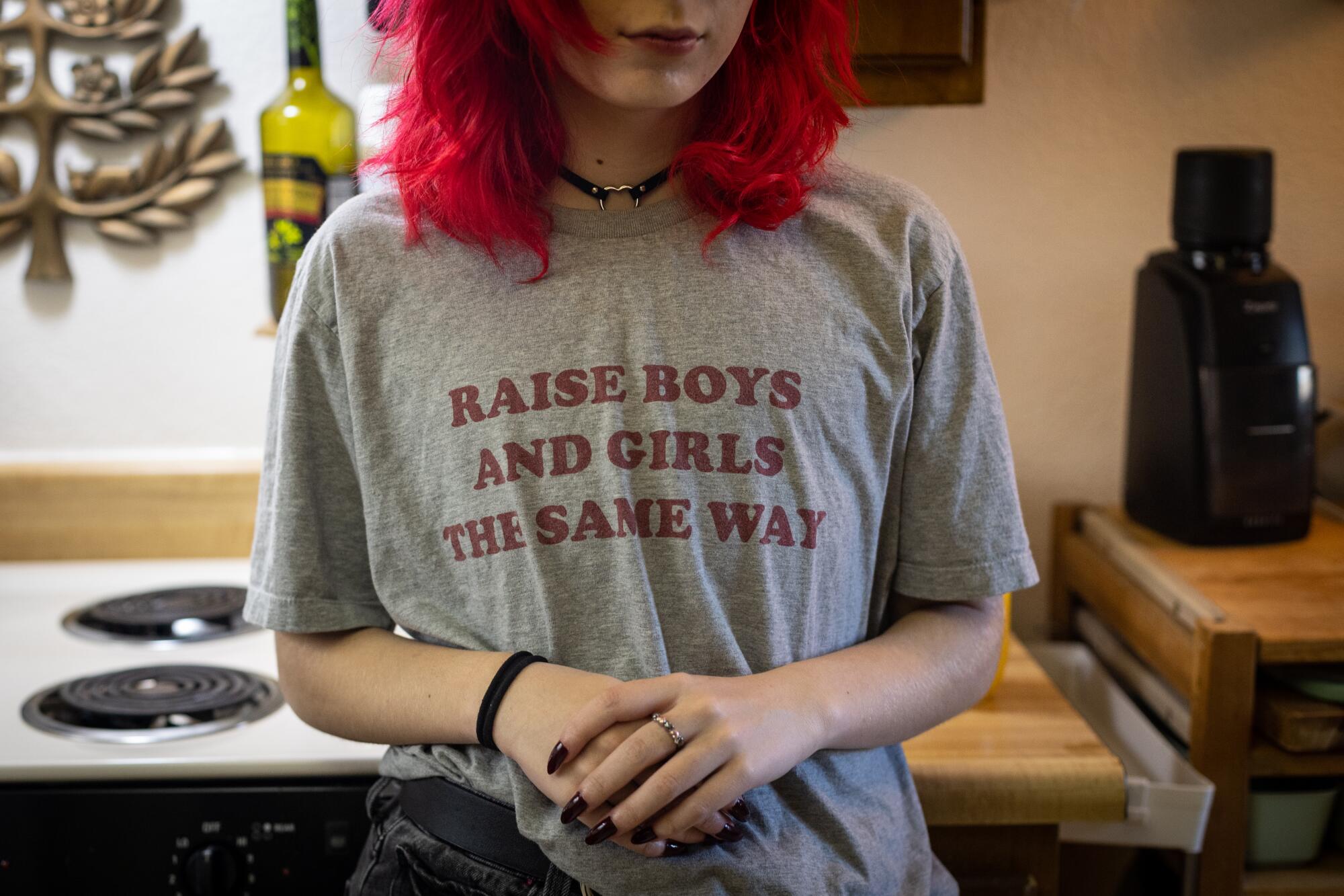 Milo Easley wears a T-shirt reading "Raise boys and girls the same way."