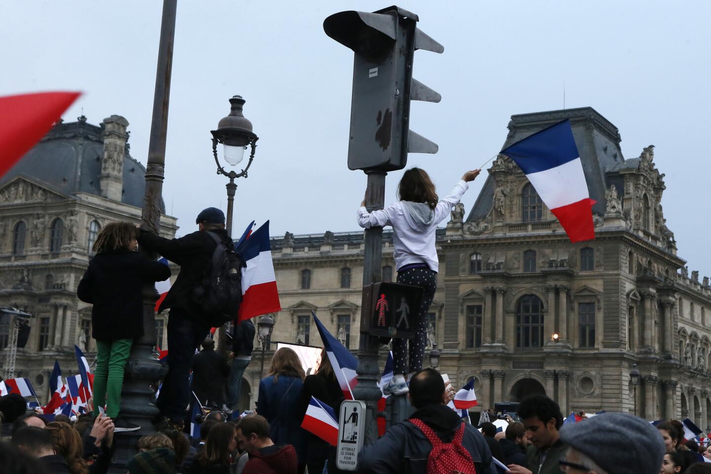 A crowd waits for President-elect Emmanuel Macron at the Louvre Museum in Paris on Sunday.