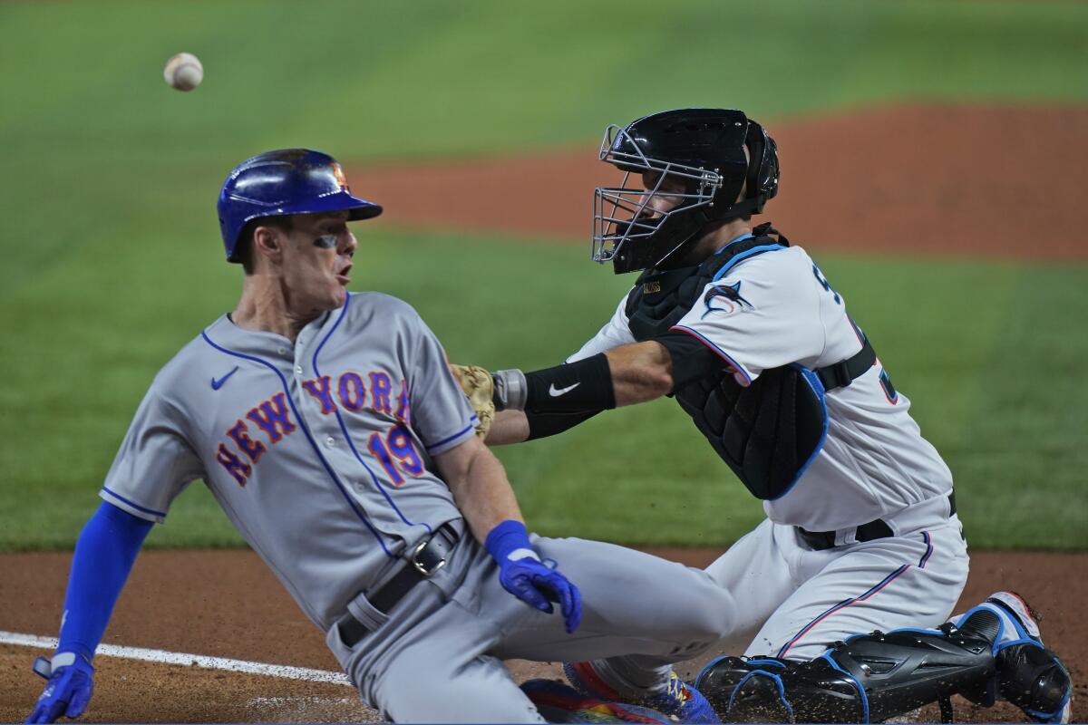 New York Mets left fielder Mark Canha warms up as a United States