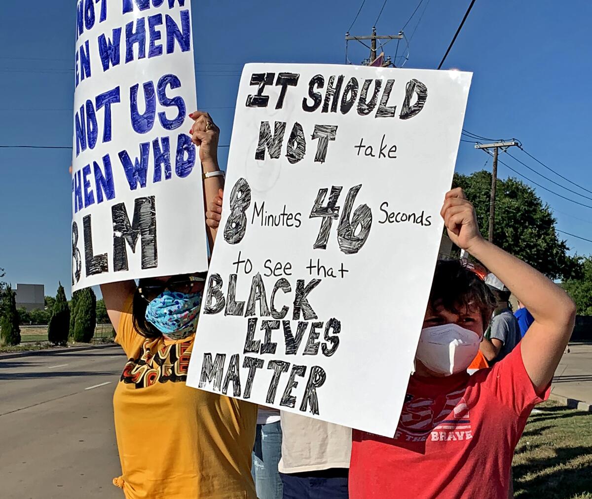 Lee Anne, left, and Tyler, 11, protest outside Grapevine, Texas, against brutality and racial bias in policing.