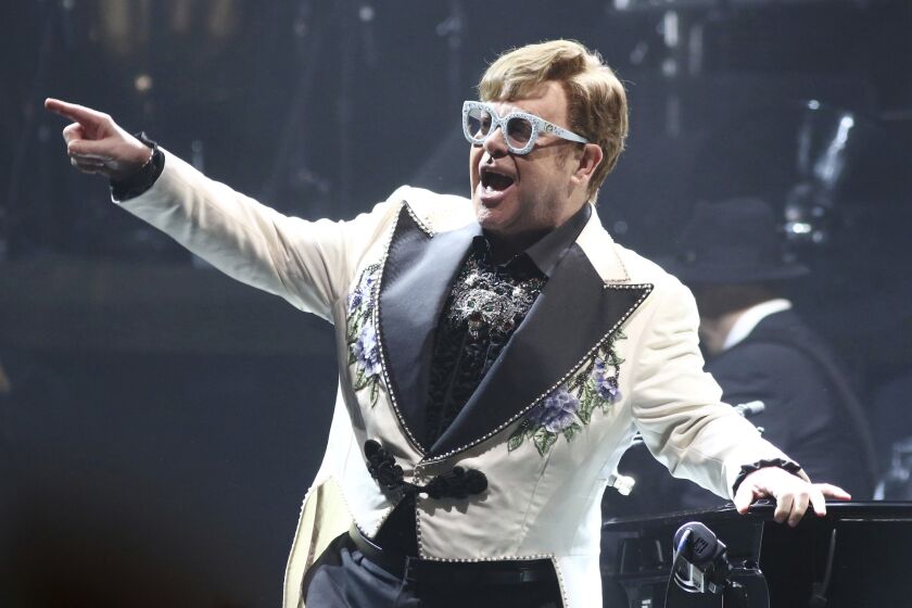 FILE - Elton John performs at Madison Square Garden during his Farewell Yellow Brick Road Tour in New York on Feb. 22, 2022. The singer has added 11 new dates on the North American leg of his farewell tour, including concerts in New Jersey, Massachusetts, California, Arizona, New Jersey and Washington. (Photo by Greg Allen/Invision/AP, File)