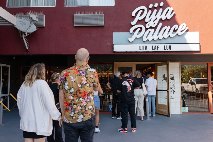 Los Angeles, CA - August 18: A line of customers waits outside Pijja Palace after opening on Thursday, Aug. 18, 2022 in Los Angeles, CA. (Wesley Lapointe / Los Angeles Times)