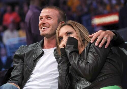 David Beckham and his wife Victoria take in the game Friday night from their courtside seats.