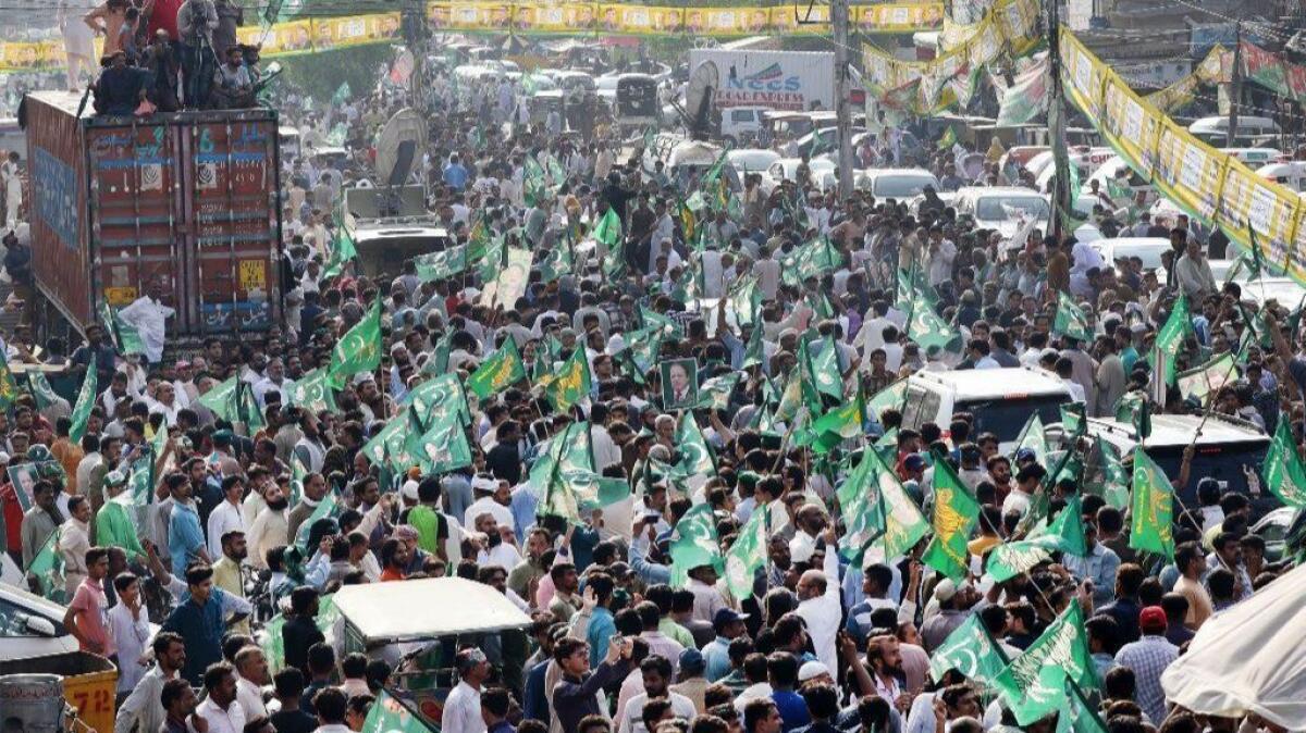 Supporters of former Prime Minister Nawaz Sharif rally in Lahore, Pakistan, before Sharif's return to the country to appeal a prison sentence for corruption charges.