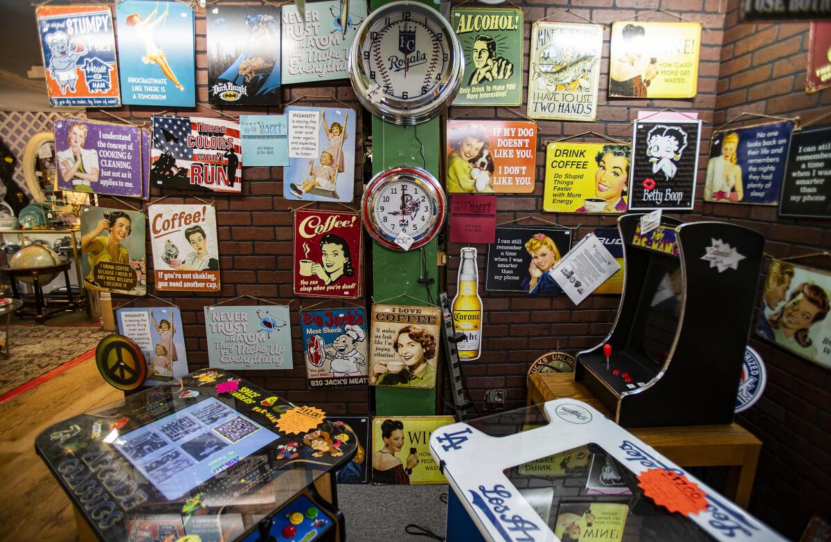 Vintage signs, clocks and games are for sale at the Mission Galleria Antique Shoppe in Riverside, Calif.