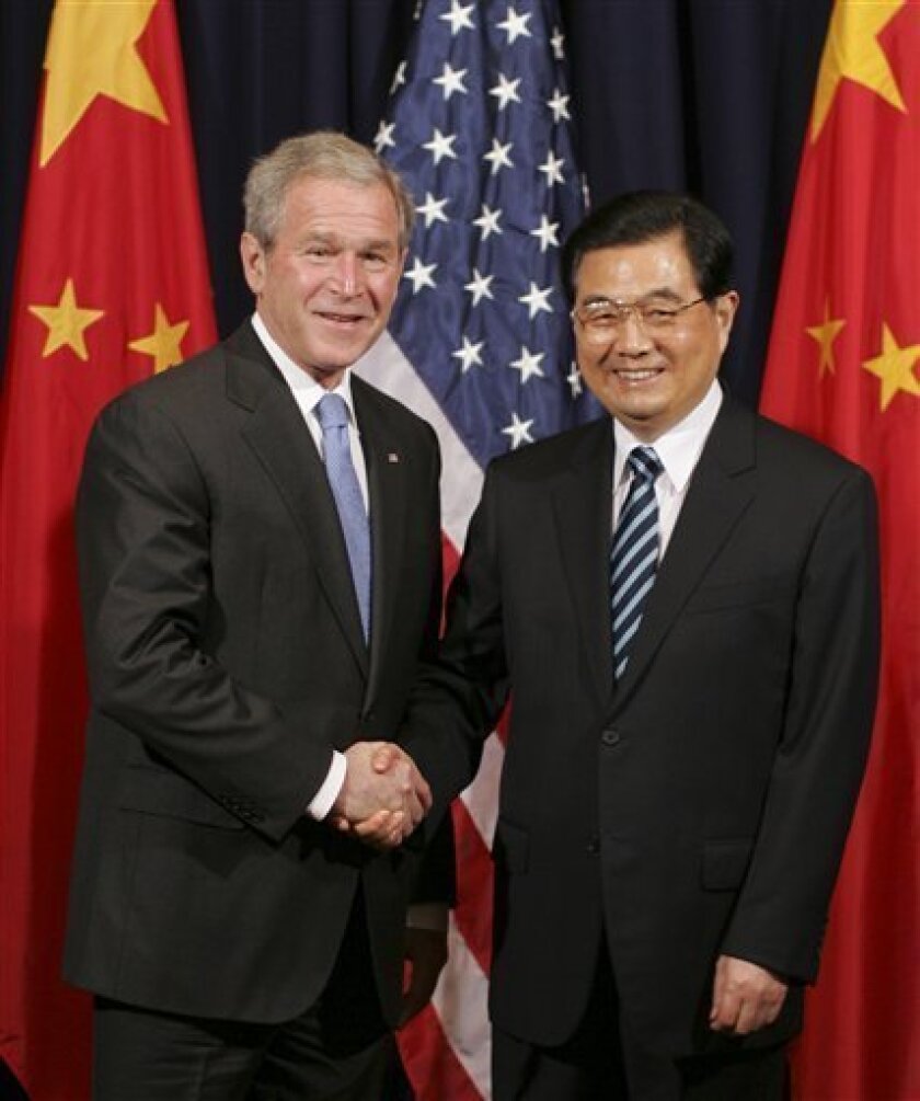U.S. President George W. Bush and with President Hu Jintao of China, right, shake hands before their meeting at the APEC Summit in Lima, Peru, Friday, Nov. 21, 2008. (AP Photo/Lawrence Jackson)