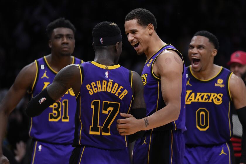 Los Angeles Lakers guard Dennis Schroder (17) celebrates with center Thomas Bryant (31).