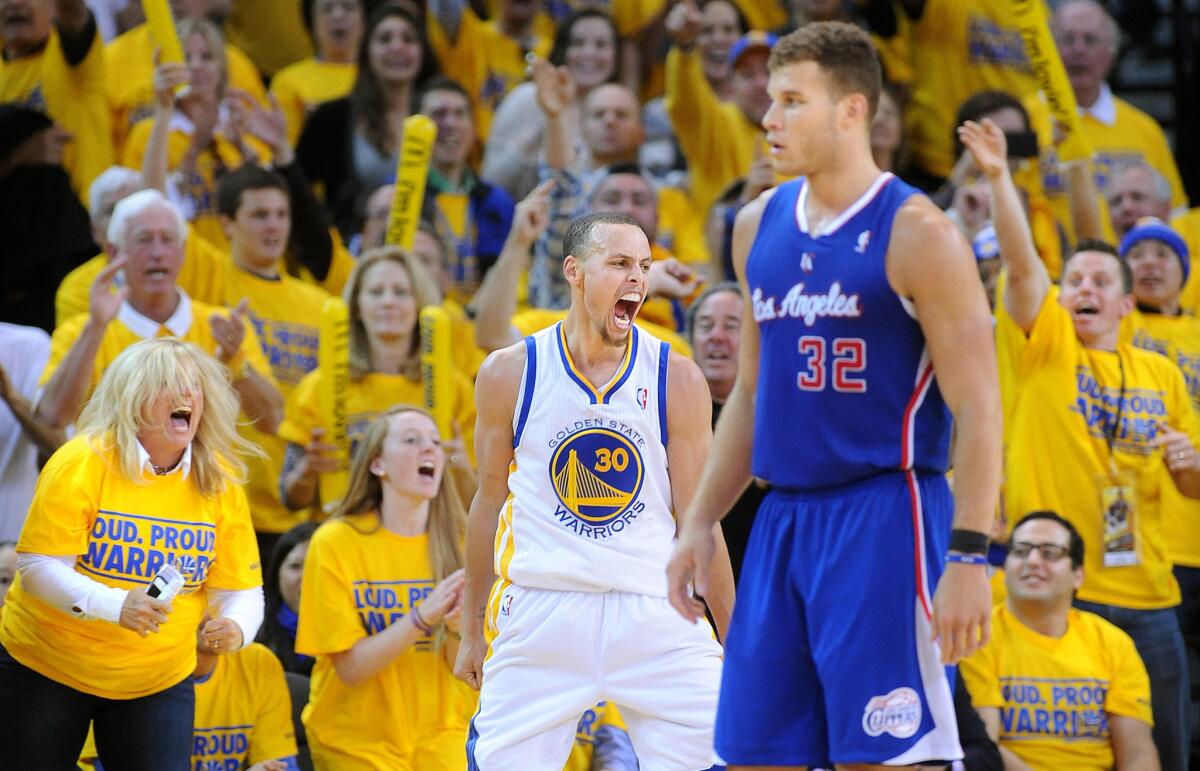 Golden State's Stephen Curry reacts near Clippers' Blake Griffin after blocking a shot in Game 4 of the NBA Western Conference playoffs on April 27, 2014.