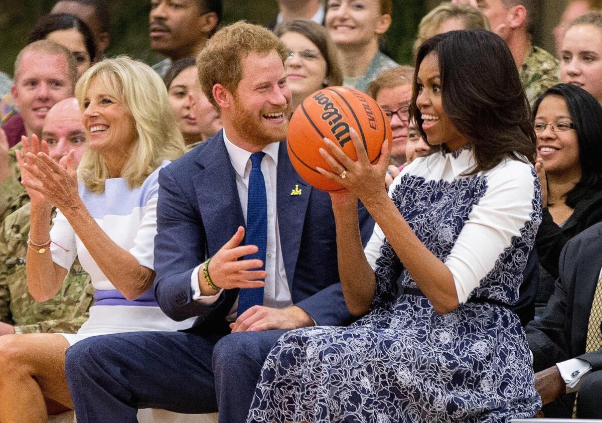 Jill Biden, left, Prince Harry and then-First Lady Michelle Obama in 2015.