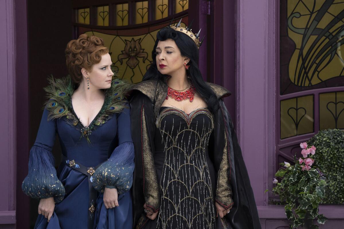 Two women in fairy tale dresses glare at one another in the movie "Disenchanted."