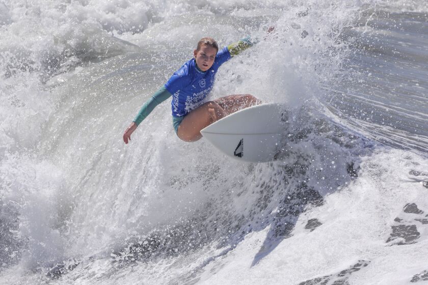 Surfer Tessa Thyssen of France competes in the first day of the Super Girl Surf Pro surf contest at the Oceanside Pier on Friday. She won the heat to advance. The event continues through Sunday.