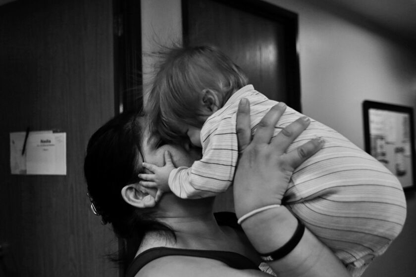 Nadia Gray, 37, kisses her son Sebastian Ramirez. Gray ended her abusive marriage, she now struggles to find an affordable place to live.