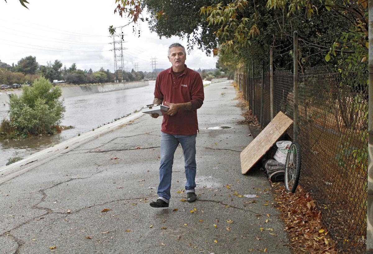 Ascencia's outreach case manager David Broadway left a note for a homeless man who was not with his belongings on the banks of the Los Angeles River at Bette Davis Park near the Glendale, Los Angeles border on a cold, rainy morning on Thursday, Nov. 21, 2013. Ascencia helps homeless find housing.