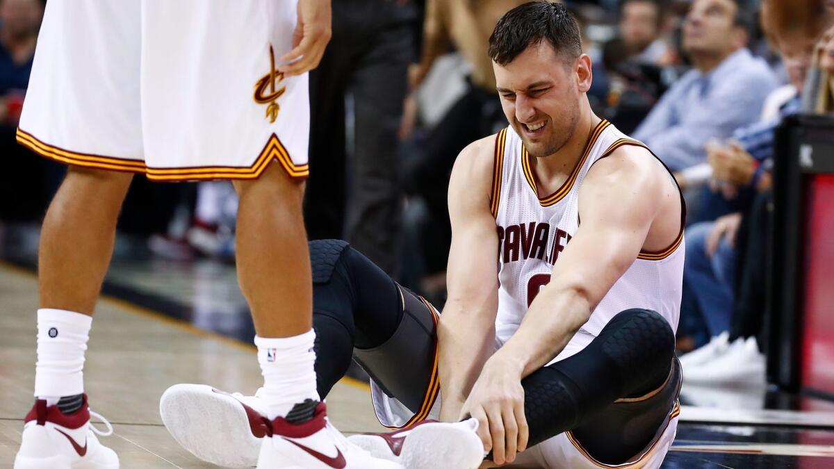 Cleveland's Andrew Bogut reacts after injuring his leg during a game against Miami on March 6.