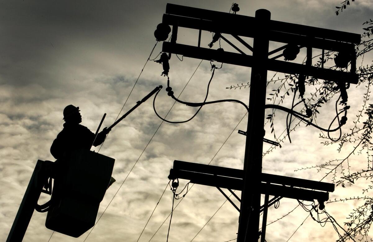 A lineman at work on a downed SDG&E power line.