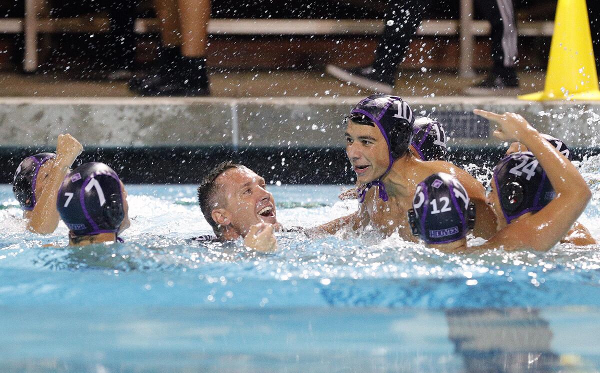 Smiling and celebrating, Hoover's head coach Kevin Witt comes to the surface after being dunked by his team in a Pacific League boys' water polo final at Arcadia High School on Thursday, October 31, 2019. Hoover won the Pacific League title beating Arcadia 10-6.