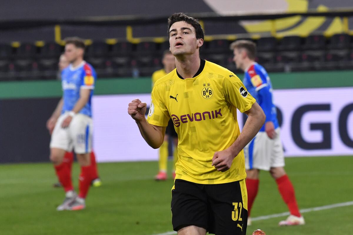 Dortmund's Giovanni Reyna celebrates after scoring his side's second goal during the German Soccer Cup semifinal match between Borussia Dortmund and Holstein Kiel in Dortmund, Germany, Saturday, May 1, 2021. (AP Photo/Martin Meissner, Pool)