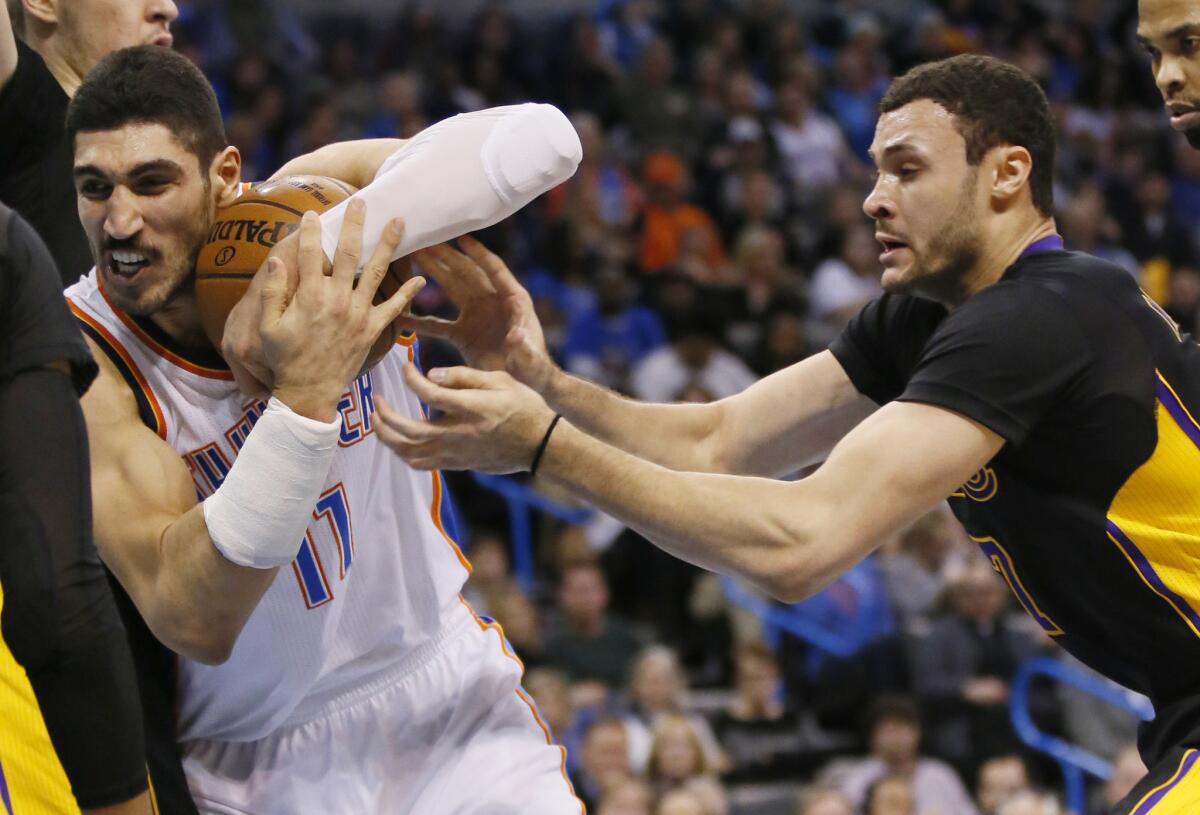 Lakers forward Larry Nance Jr. tries to steal the ball from Thunder center Enes Kanter during the fourth quarter Friday.