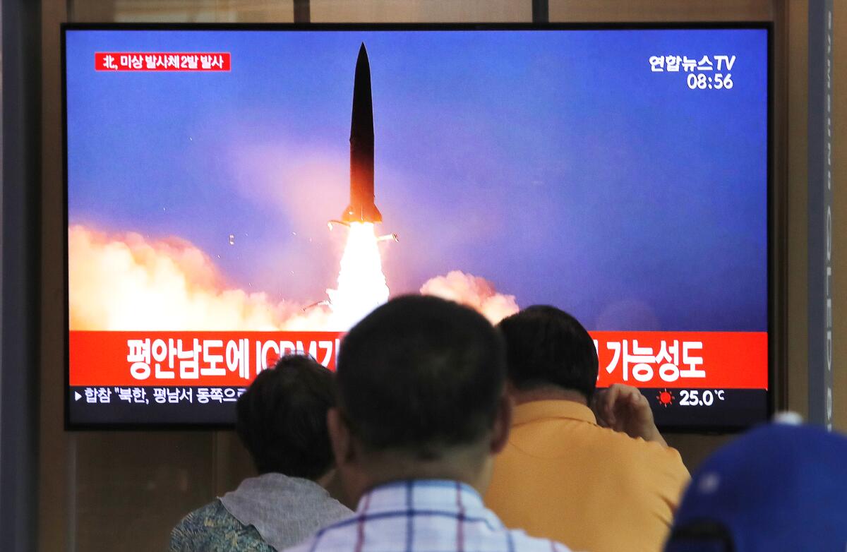 People watch a TV showing a file image of a North Korea's missile launch during a news program at the Seoul Railway Station in Seoul, South Korea, Tuesday, Sept. 10, 2019. North Korea launched at least two unidentified projectiles toward the sea on Tuesday, South Korea's military said, hours after the North offered to resume nuclear diplomacy with the United States but warned its dealings with Washington may end without new U.S. proposals. The sign reads "North Korea launched at least two unidentified projectiles." (AP Photo/Ahn Young-joon)