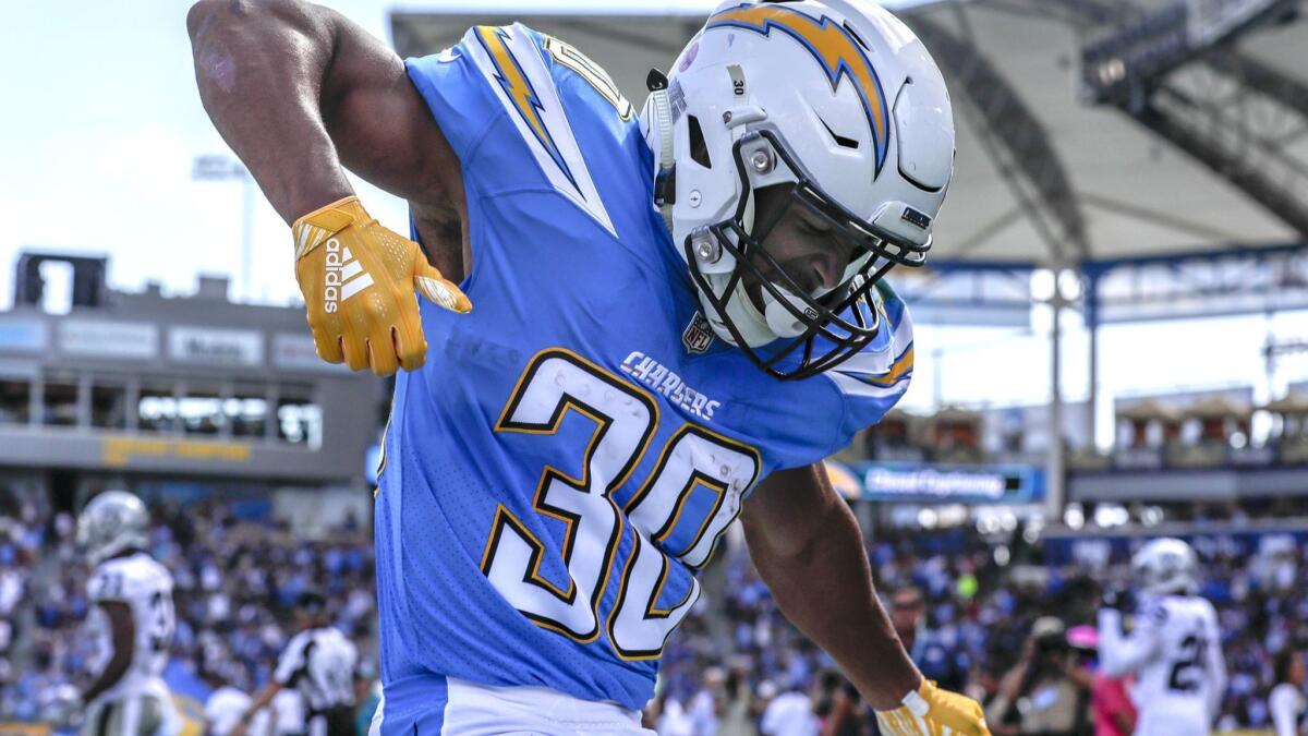 Chargers running back Austin Ekeler strums his air guitar in the end zone after scoring a touchdown on a 44-yard screen pass from Philip Rivers.