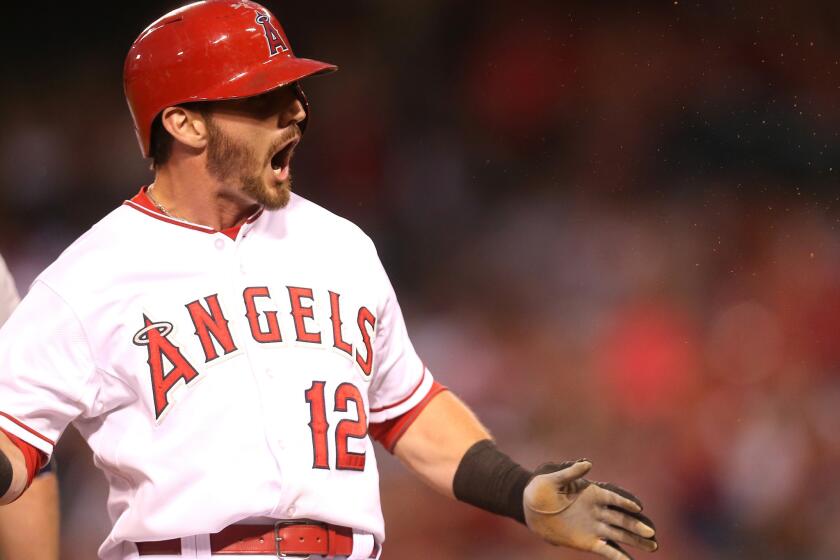 Angels second baseman Johnny Giavotella reacts after hitting a triple against the Mariners.