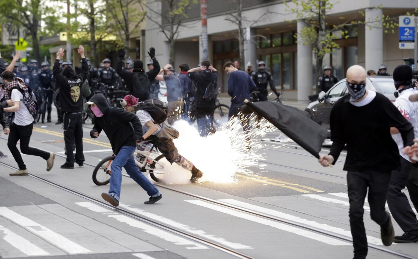 Police and protesters clash Friday in downtown Seattle.