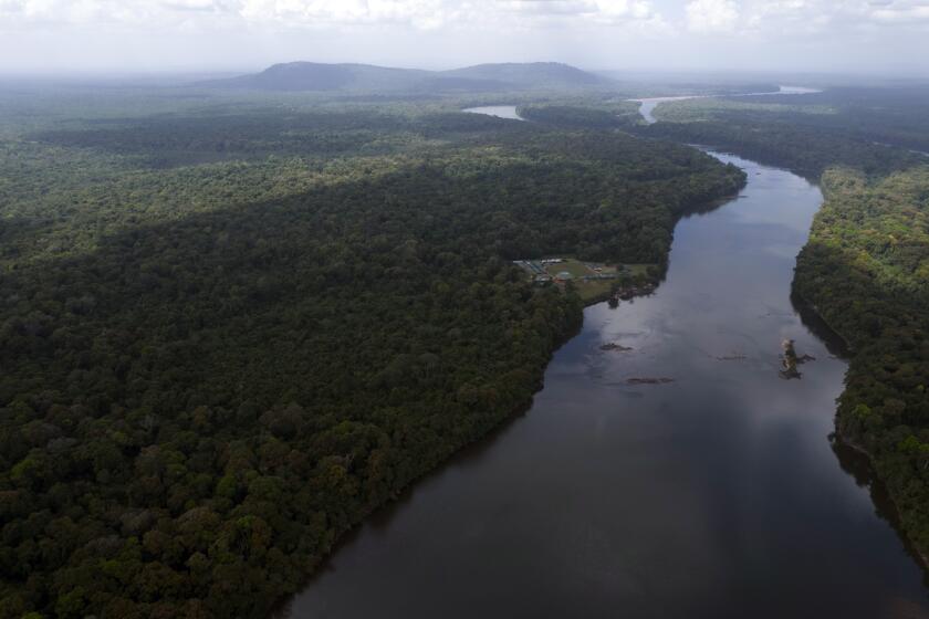 The Essequibo River flows through Kurupukari crossing in Guyana, Saturday, Nov. 19, 2023. Venezuela has long claimed Guyana’s Essequibo region, a territory larger than Greece and rich in oil and minerals. (AP Photo/Juan Pablo Arraez)