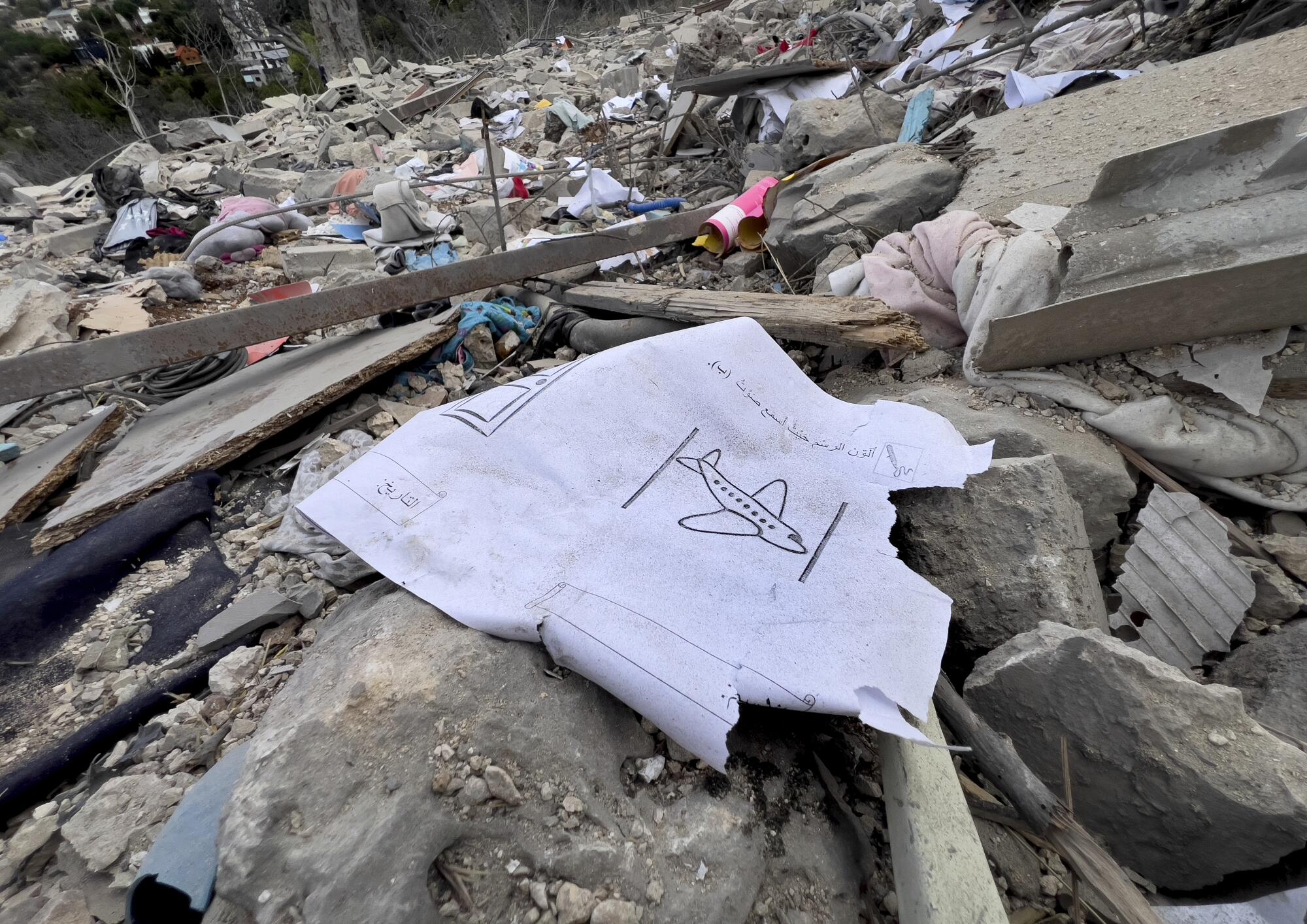 Among the rubble is a drawing of an airplane.