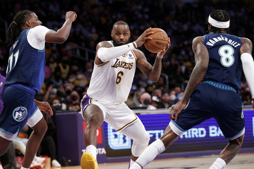 Los Angeles Lakers forward LeBron James (6) drives between Minnesota Timberwolves center Naz Reid.