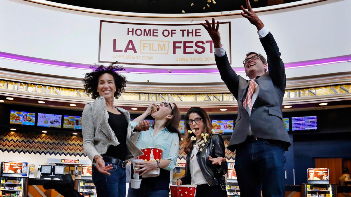 Los Angeles Film Festival director Stephanie Allain, left, programmer Jennifer Cochis and associate director Roya Rastegar celebrate the new fest with Josh Welsh, president of Film Independent, at the Regal Cinemas in downtown Los Angeles.