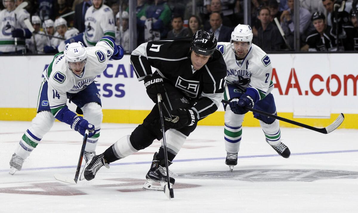 Kings forward Milan Lucic starts on a break away as Canucks forward Alex Burrows (14) and defenseman Dan Hamhuis (2) give chase during the second period of a game Oct. 13.