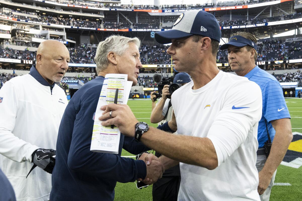 Chargers coach Brandon Staley and Seattle Seahawks coach Pete Carroll shake hands.