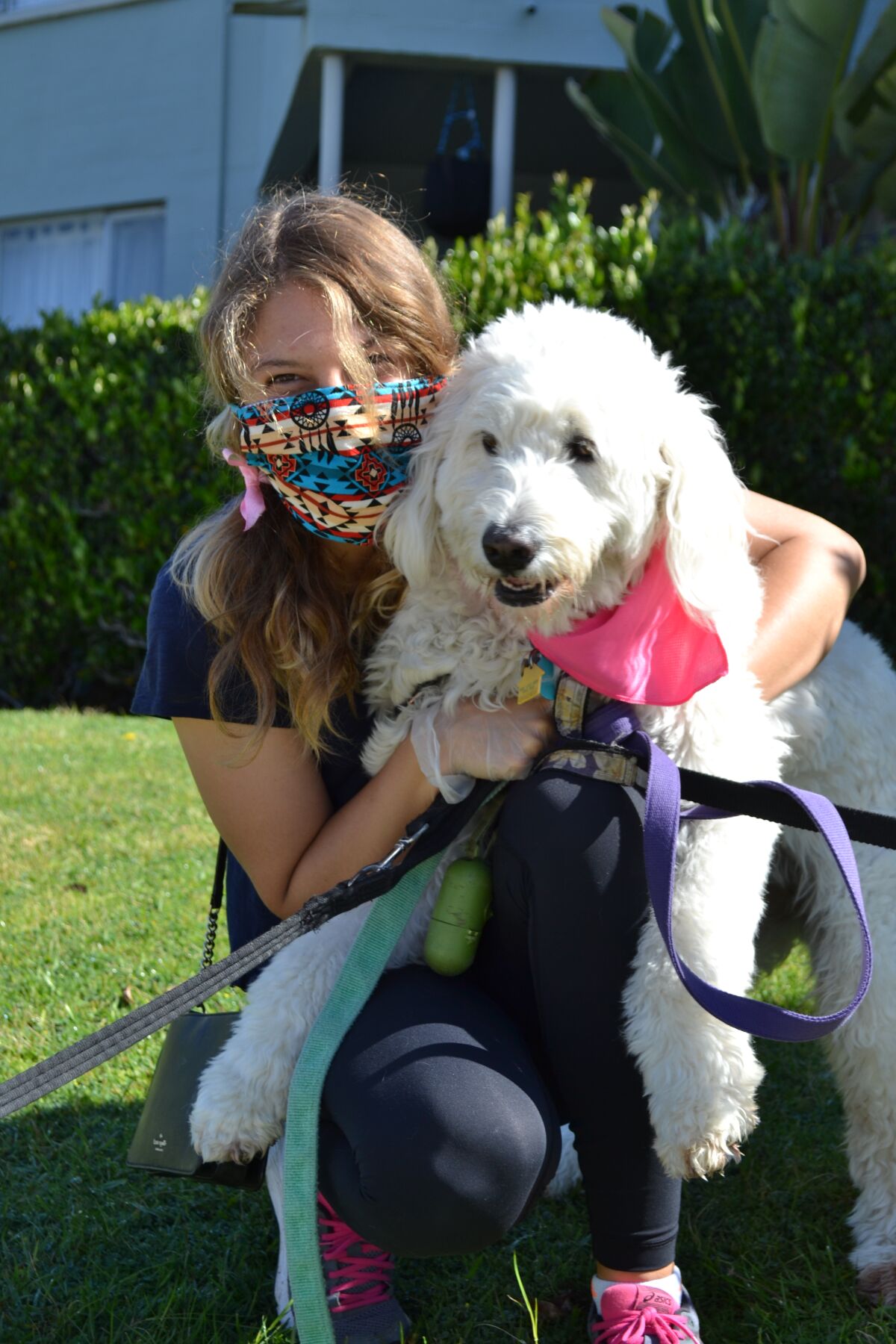 La Jolla dog walker Molly Ludwig is masked and ready.