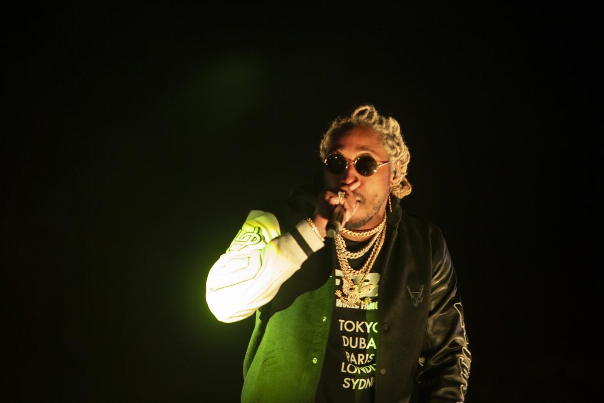 Rapper with shades and dyed blond dreadlocks