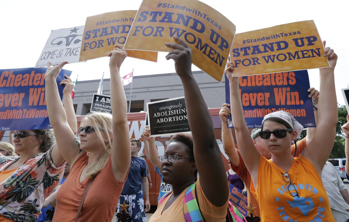 Opponents and supporters of an abortion bill demonstrate at the state Capitol in Austin, Texas, in 2013.