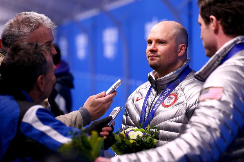 Bronze medalists Steven Holcomb, left, and Steven Langton of the United States team 1 give an interview after the Olympics medal ceremony for the Men's Two-Man Bobsleigh at Medals Plaza on Feb. 18, 2014 in Sochi, Russia.