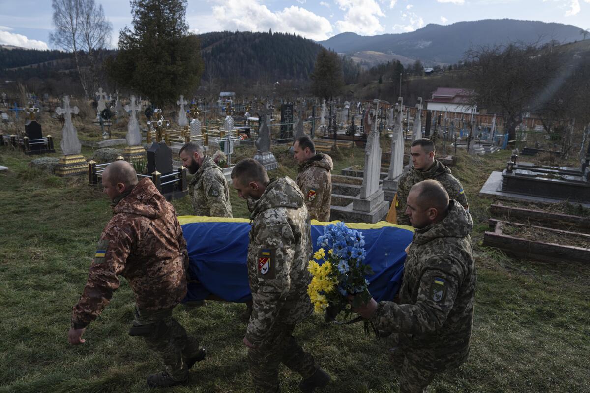 Ukrainian servicemen carrying the coffin of a comrade