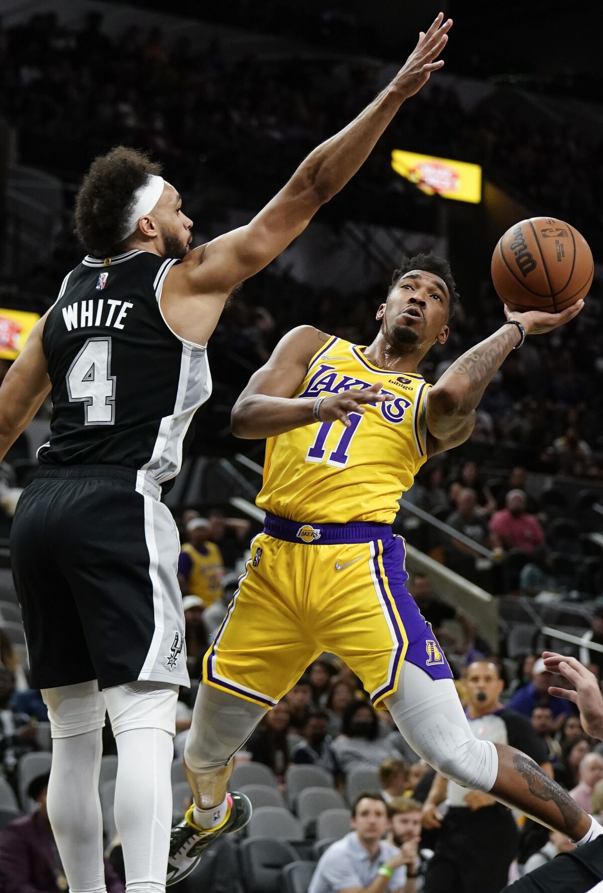 Lakers' Malik Monk shoots against San Antonio Spurs' Derrick White.