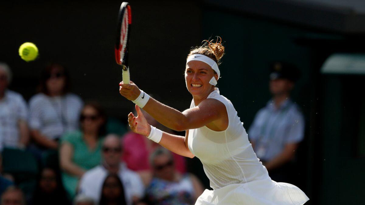 Petra Kvitova returns to Johanna Larsson during their singles match on the opening day at the Wimbledon Tennis Championships in London Monday.