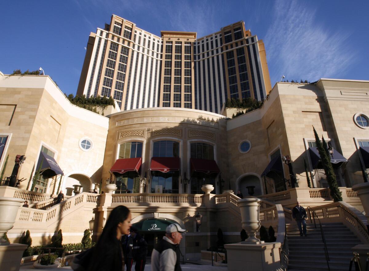 The Palazzo Resort Hotel Casino shimmers at dusk on the Las Vegas Strip. A class-action lawsuit claims the hotel's resort fees are not clearly disclosed when guests book rooms.