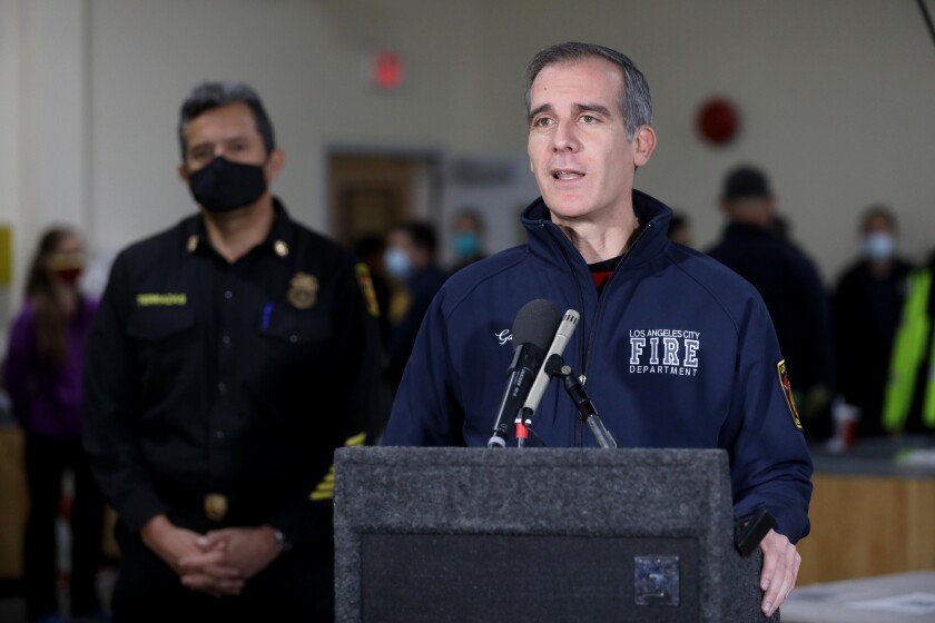 Los Angeles Fire Chief Ralph M. Terrazas stands behind Mayor Eric Garcetti at a news conference.